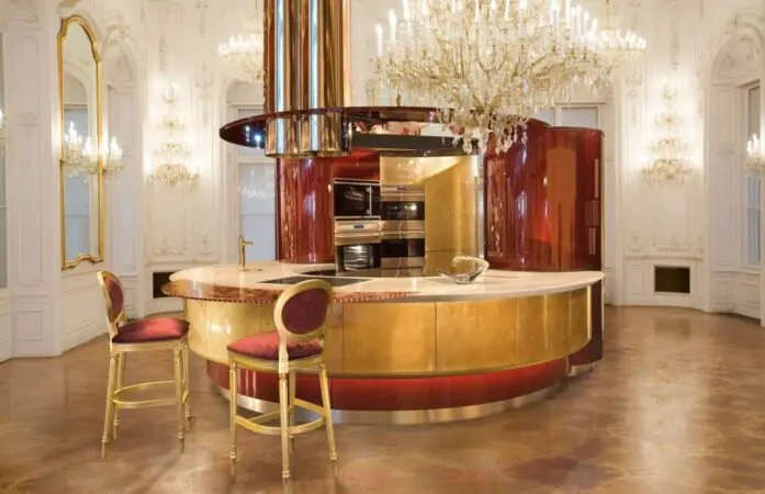 The world's most expensive fitted kitchen, Colosseo Oro, features a gold and red color scheme and a chandelier.